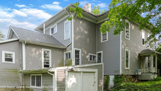 206 W Harris St, Charlotte, MI 48813 - rear view of property with a chimney and a storage unit