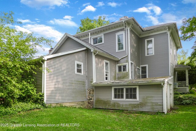 206 W Harris St, Charlotte, MI 48813 - back of property featuring a yard and a chimney