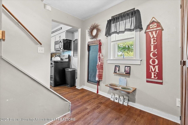 424 N Morrice Rd, Morrice, MI 48857 - foyer with wood finished floors, baseboards, and stairs