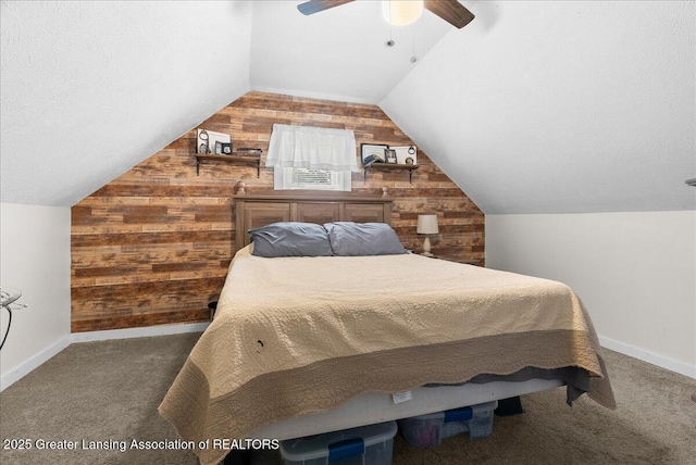 424 N Morrice Rd, Morrice, MI 48857 - carpeted bedroom with wooden walls, vaulted ceiling, baseboards, and ceiling fan