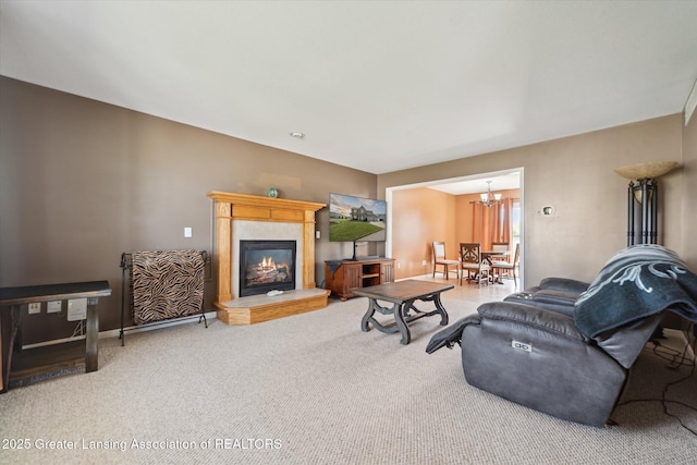 5619 Bittern Dr, Holt, MI 48842 - living area featuring carpet flooring, a tiled fireplace, a chandelier, and baseboards
