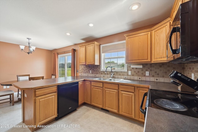 5619 Bittern Dr, Holt, MI 48842 - kitchen featuring black appliances, a sink, a peninsula, a chandelier, and backsplash