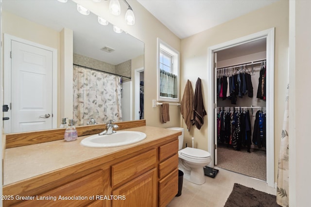 5619 Bittern Dr, Holt, MI 48842 - bathroom with toilet, vanity, a walk in closet, and a shower with curtain