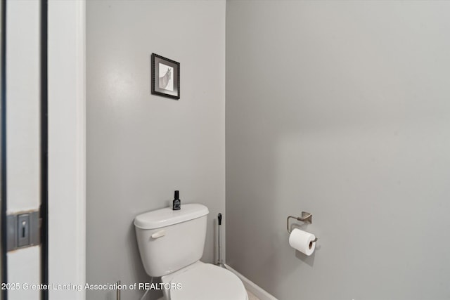 5619 Bittern Dr, Holt, MI 48842 - bathroom featuring toilet and baseboards