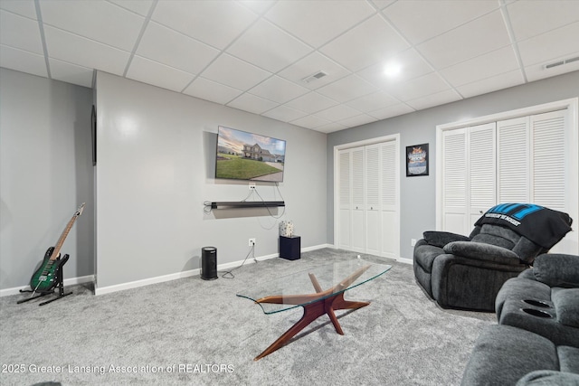 5619 Bittern Dr, Holt, MI 48842 - living room featuring carpet, a paneled ceiling, and baseboards