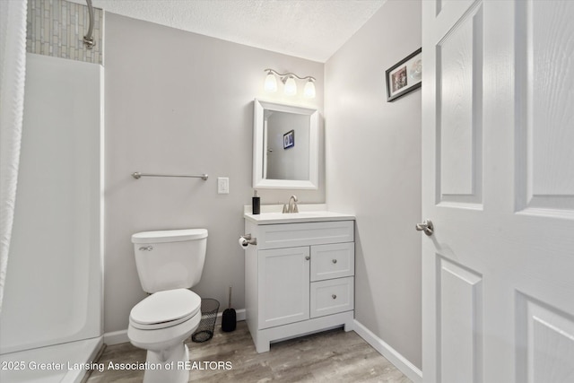 5619 Bittern Dr, Holt, MI 48842 - full bathroom featuring wood finished floors, toilet, vanity, a textured ceiling, and a shower
