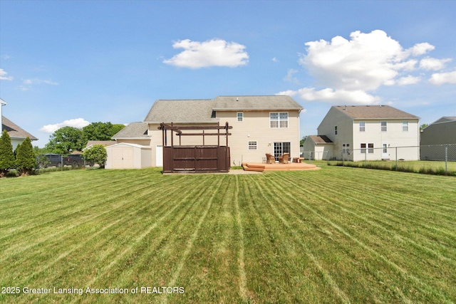 5619 Bittern Dr, Holt, MI 48842 - back of property with a deck and a jacuzzi
