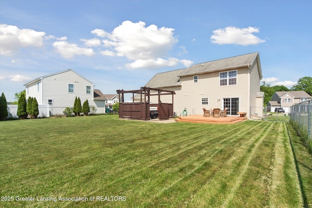 5619 Bittern Dr, Holt, MI 48842 - back of house with a jacuzzi and a wooden deck