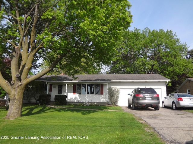 14311 Chandler Rd, Bath, MI 48808 - ranch-style home with driveway, a garage, and a front lawn