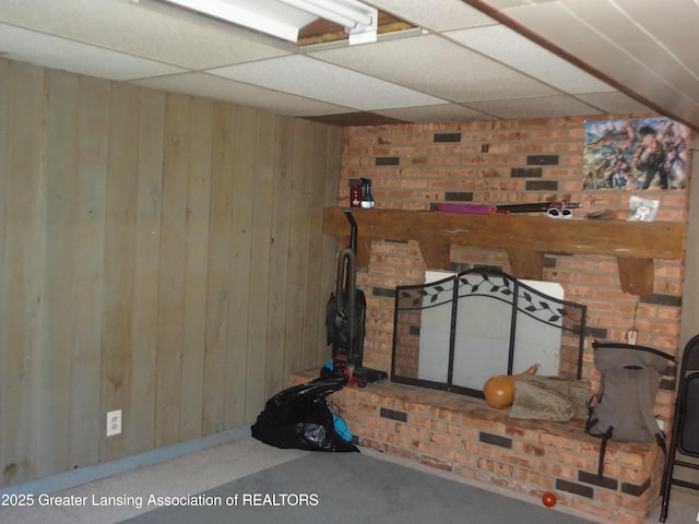 14311 Chandler Rd, Bath, MI 48808 - living room featuring a paneled ceiling, wooden walls, and baseboards