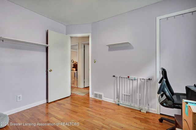 14311 Chandler Rd, Bath, MI 48808 - unfurnished office with wood finished floors and baseboards