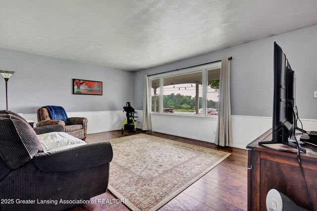 14311 Chandler Rd, Bath, MI 48808 - living area with wood finished floors and a wainscoted wall
