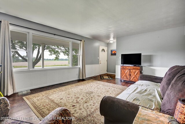 14311 Chandler Rd, Bath, MI 48808 - living room featuring a wainscoted wall and wood finished floors