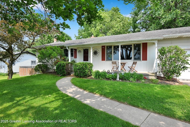 14311 Chandler Rd, Bath, MI 48808 - ranch-style home with covered porch, a front yard, a chimney, and a shingled roof