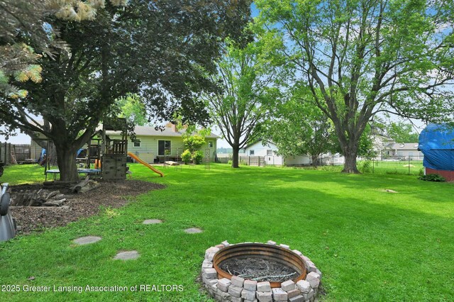 14311 Chandler Rd, Bath, MI 48808 - view of yard featuring a playground and a fire pit