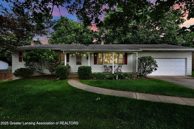 14311 Chandler Rd, Bath, MI 48808 - single story home with a porch, driveway, an attached garage, and a front lawn