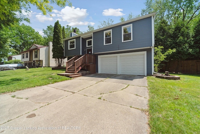 2500 Champion Way, Lansing, MI 48910 - split foyer home featuring an attached garage, concrete driveway, and a chimney