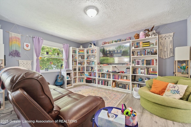2500 Champion Way, Lansing, MI 48910 - living area featuring a textured ceiling and wood finished floors