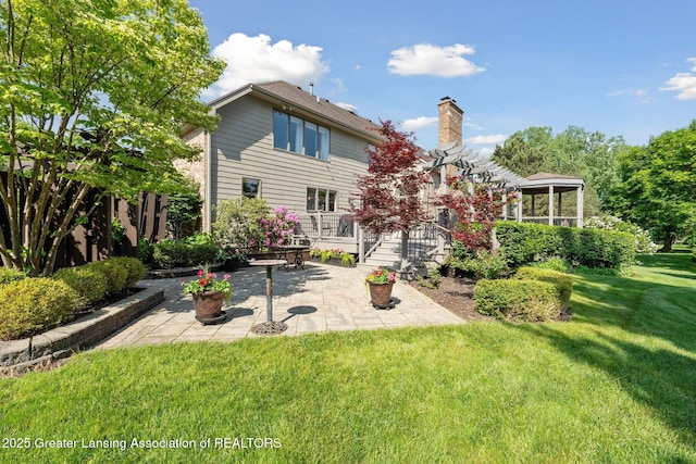 1209 Windale Pl, East Lansing, MI 48823 - rear view of property with a patio area, a yard, and a chimney