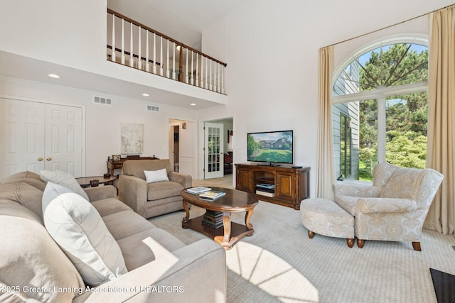 1209 Windale Pl, East Lansing, MI 48823 - living area featuring light colored carpet, a high ceiling, and recessed lighting