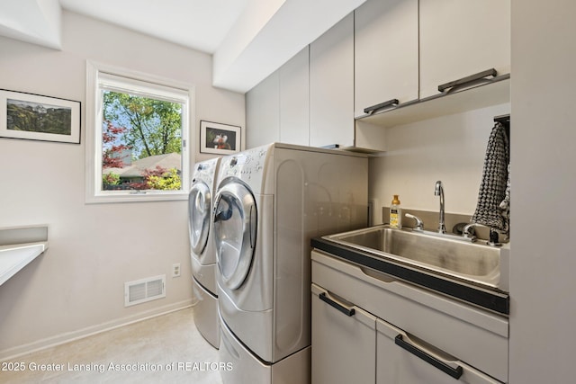 1209 Windale Pl, East Lansing, MI 48823 - laundry room with cabinet space, separate washer and dryer, and baseboards