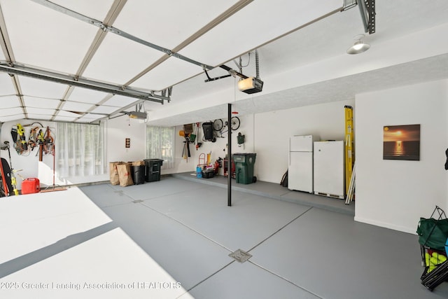 1209 Windale Pl, East Lansing, MI 48823 - garage featuring freestanding refrigerator and a garage door opener