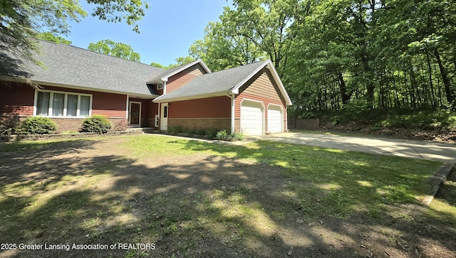 4423 Hyatt St, Eaton Rapids, MI 48827 - view of front of house featuring stone siding, an attached garage, a shingled roof, and concrete driveway