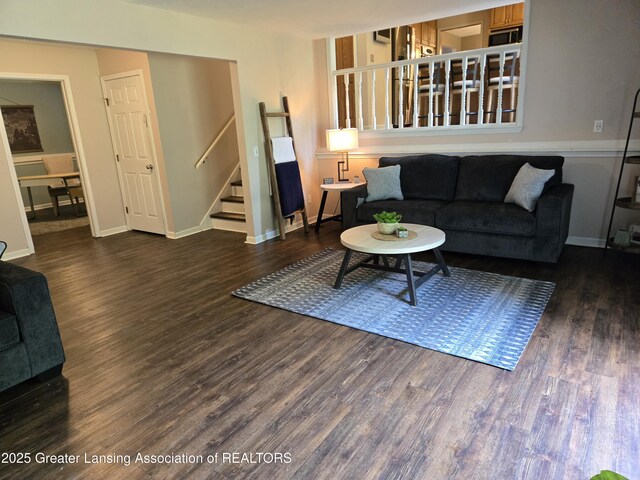 4423 Hyatt St, Eaton Rapids, MI 48827 - living area featuring stairs, wood finished floors, and baseboards