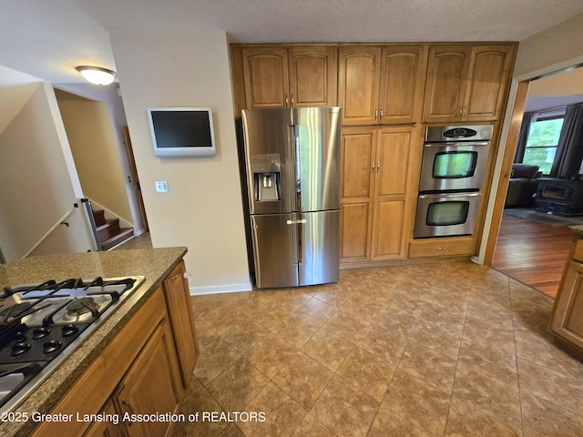 4423 Hyatt St, Eaton Rapids, MI 48827 - kitchen with stainless steel appliances and brown cabinetry