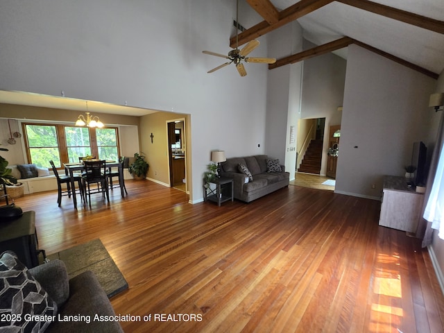 4423 Hyatt St, Eaton Rapids, MI 48827 - living room with stairway, wood finished floors, high vaulted ceiling, a chandelier, and beamed ceiling