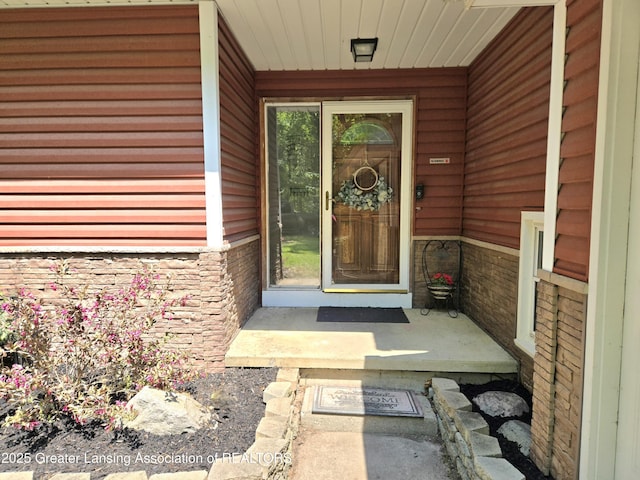 4423 Hyatt St, Eaton Rapids, MI 48827 - doorway to property featuring stone siding