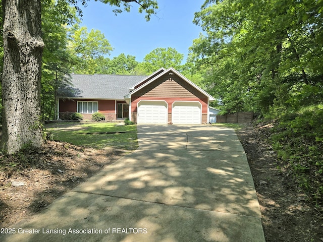 4423 Hyatt St, Eaton Rapids, MI 48827 - view of front of property with an attached garage, brick siding, and driveway