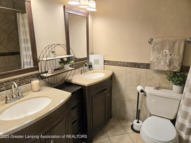 4423 Hyatt St, Eaton Rapids, MI 48827 - full bathroom featuring vanity, toilet, tile walls, wainscoting, and a shower with curtain