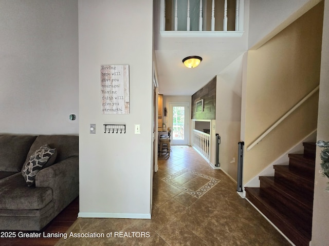 4423 Hyatt St, Eaton Rapids, MI 48827 - corridor with stairs, baseboards, and tile patterned flooring