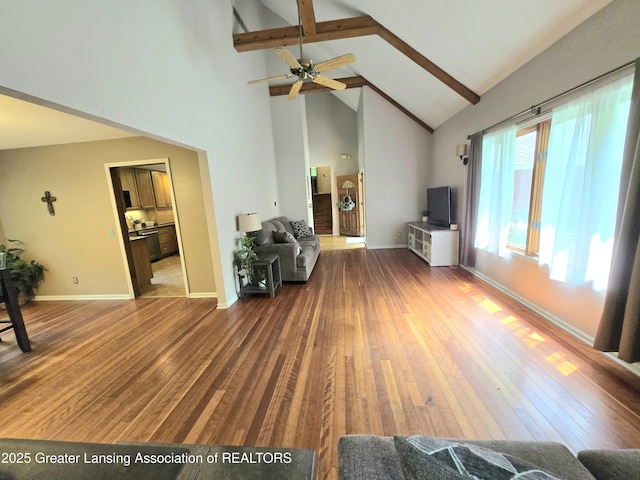 4423 Hyatt St, Eaton Rapids, MI 48827 - living area featuring high vaulted ceiling, wood-type flooring, beamed ceiling, a ceiling fan, and baseboards