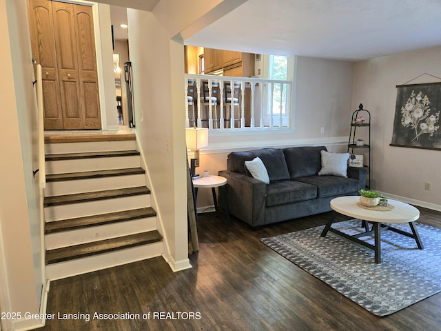 4423 Hyatt St, Eaton Rapids, MI 48827 - living room with dark wood-type flooring, baseboards, and stairs