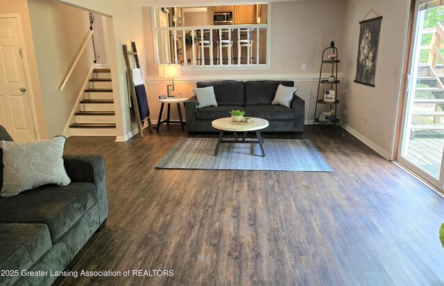 4423 Hyatt St, Eaton Rapids, MI 48827 - living area featuring wood finished floors, stairway, and baseboards