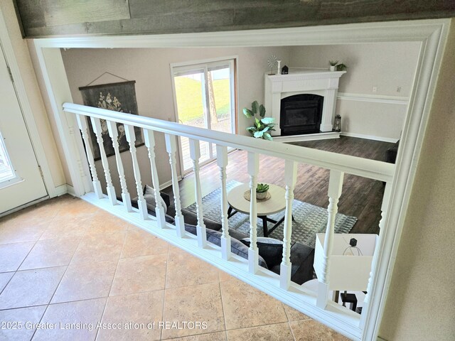 4423 Hyatt St, Eaton Rapids, MI 48827 - stairway with tile patterned floors and a glass covered fireplace