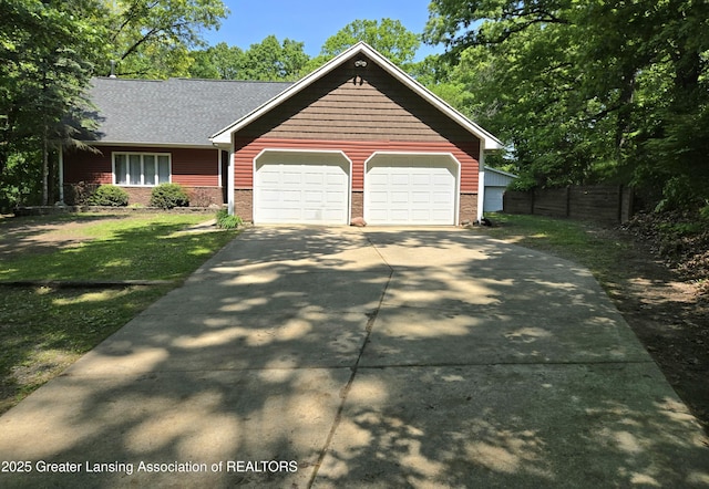 4423 Hyatt St, Eaton Rapids, MI 48827 - view of front of house with driveway, an attached garage, and brick siding