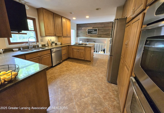 4423 Hyatt St, Eaton Rapids, MI 48827 - kitchen featuring appliances with stainless steel finishes, a sink, brown cabinets, recessed lighting, and a peninsula