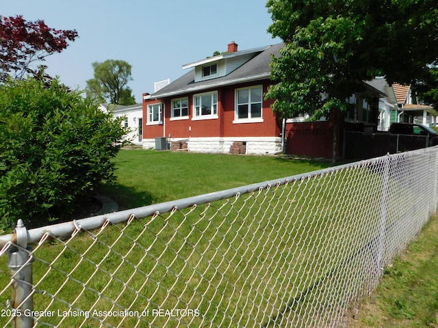 1305 May St, Lansing, MI 48906 - rear view of property featuring central AC unit and a chimney
