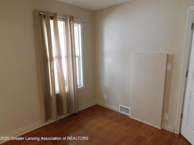 1305 May St, Lansing, MI 48906 - unfurnished room featuring plenty of natural light, wood finished floors, and baseboards