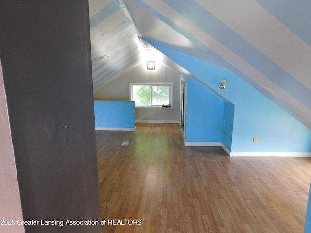 1305 May St, Lansing, MI 48906 - bonus room with wood finished floors, lofted ceiling, and baseboards