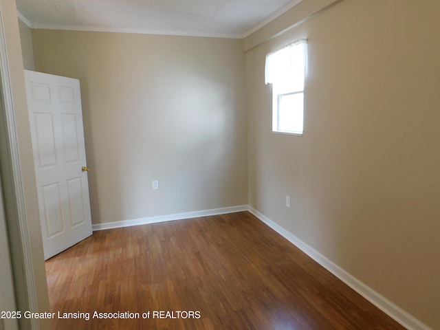 1305 May St, Lansing, MI 48906 - spare room featuring wood finished floors, ornamental molding, and baseboards