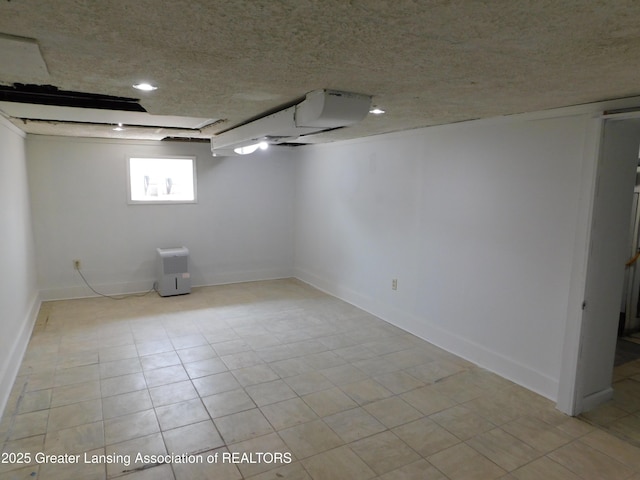 1305 May St, Lansing, MI 48906 - below grade area with baseboards and a textured ceiling