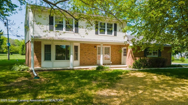 5775 Zimmer Rd, Williamston, MI 48895 - traditional-style home with brick siding, a front lawn, and covered porch
