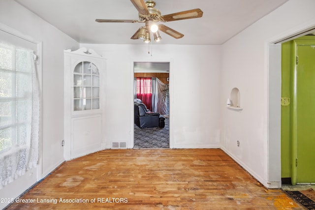 1615 Inverness Ave, Lansing, MI 48915 - empty room featuring plenty of natural light, wood finished floors, and ceiling fan