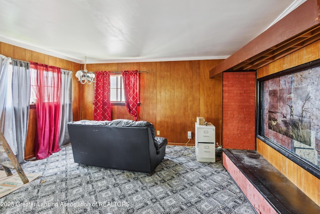 1615 Inverness Ave, Lansing, MI 48915 - carpeted living area featuring wood walls and a chandelier