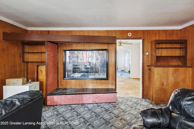 1615 Inverness Ave, Lansing, MI 48915 - living room featuring wood walls, ornamental molding, and arched walkways