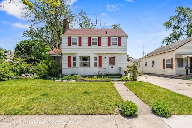 1615 Inverness Ave, Lansing, MI 48915 - colonial house with a chimney and a front lawn